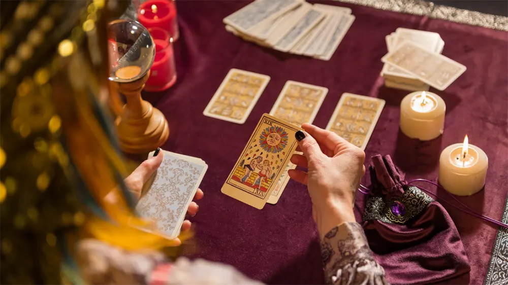 How to Ask Tarot Questions: Choosing the Right One for Accurate Insights 2 Person meditating with tarot cards in hand for setting question intent